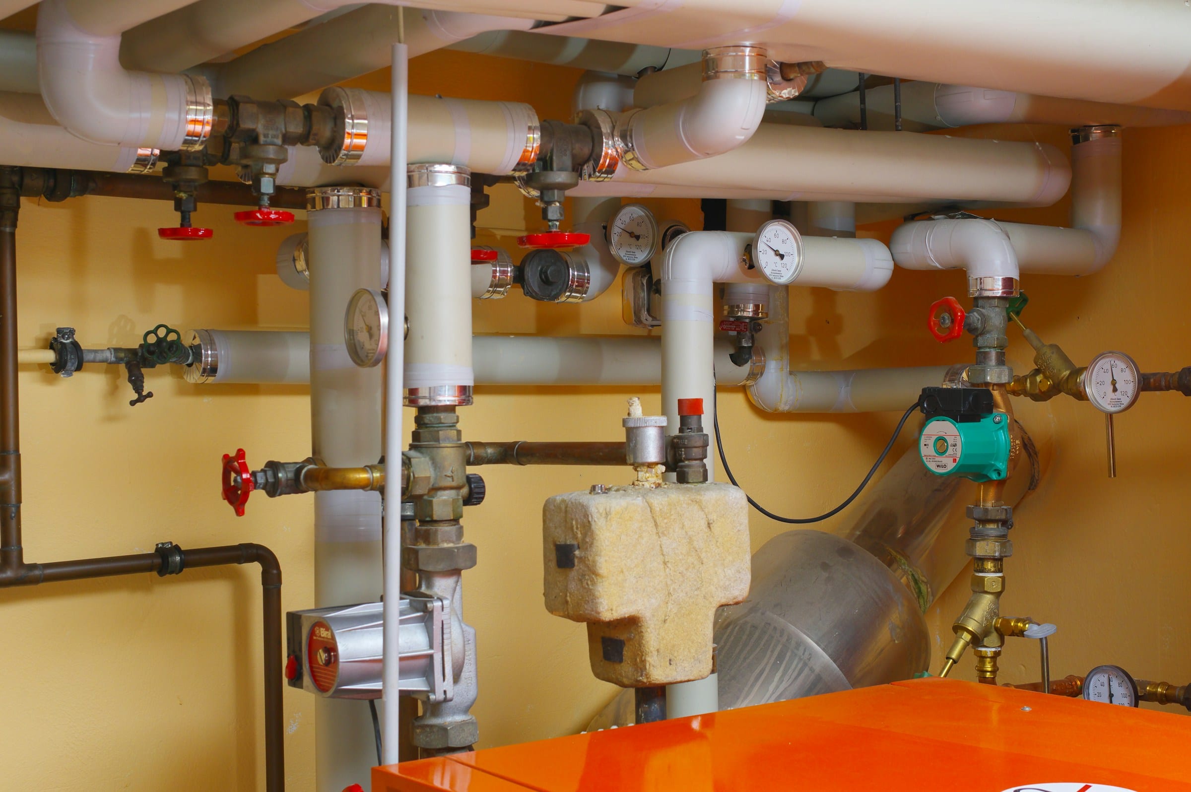Utility room with water treatment tanks, valves and pressure gauges